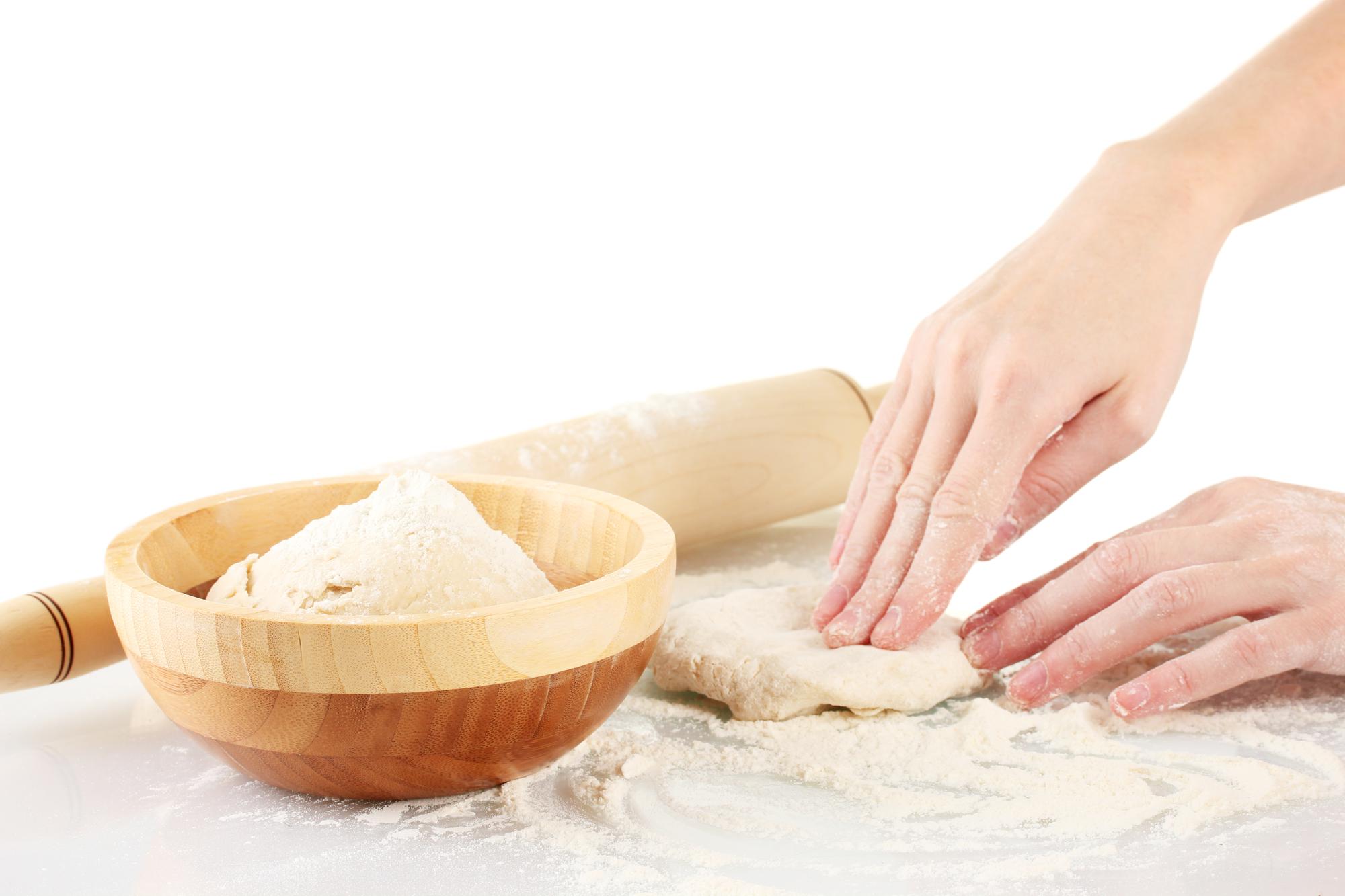 Hands shaping dough